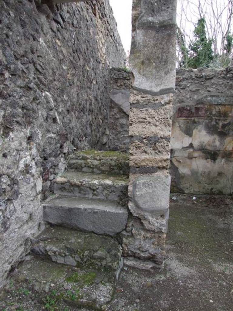 V.5.2 Pompeii. December 2007. Looking south to steps to upper floor in south-east corner of atrium. The doorway on the west side (right) of the steps led to a cubiculum d. The south wall, visible in the background, was decorated in the first style. These six masonry steps would have continued with wooden stairs. These steps and stairs would have been against the east wall and led above both cubiculum d and cubiculum c. See Notizie degli Scavi di Antichit, 1895, p.150
