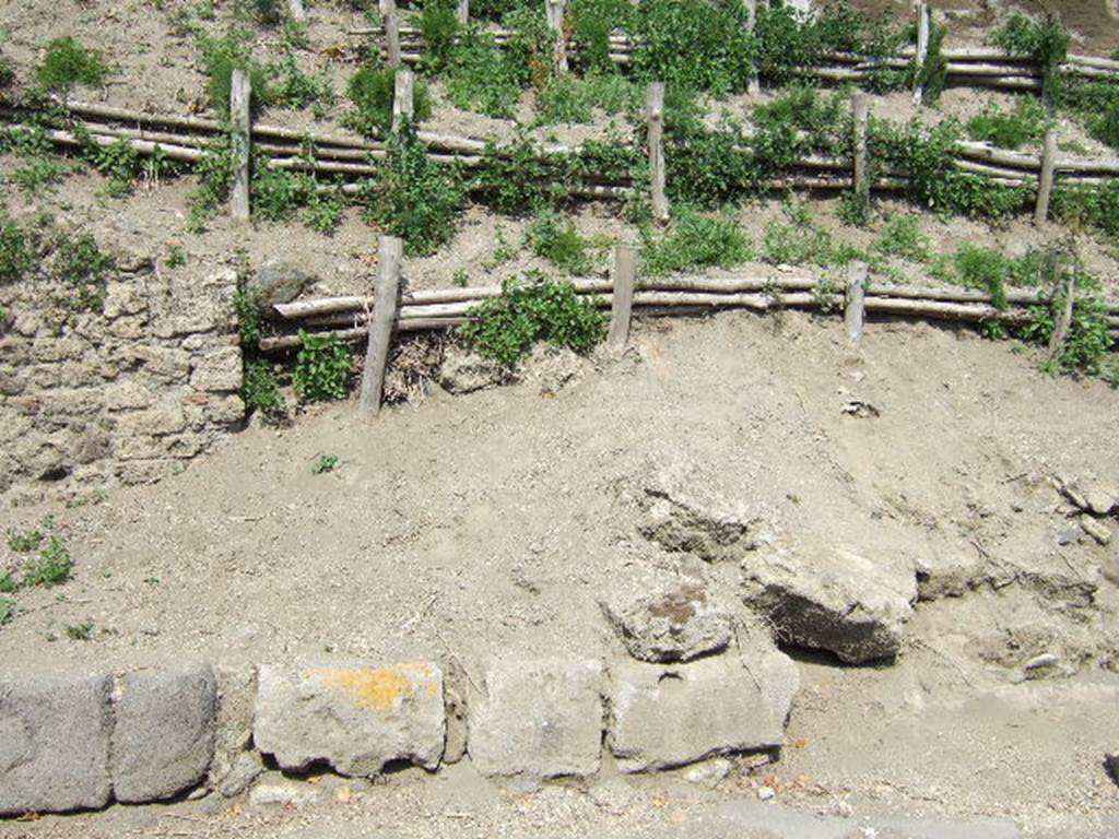 V.6.6 Pompeii, (on right). May 2006. Unexcavated façade/boundary wall.
