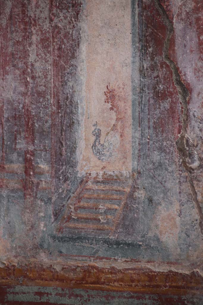 V.6.12 Pompeii. October 2020. 
Detail from architectural decoration (? a peacock) on west side of central painting on south wall of cubiculum.
Photo courtesy of Klaus Heese.
