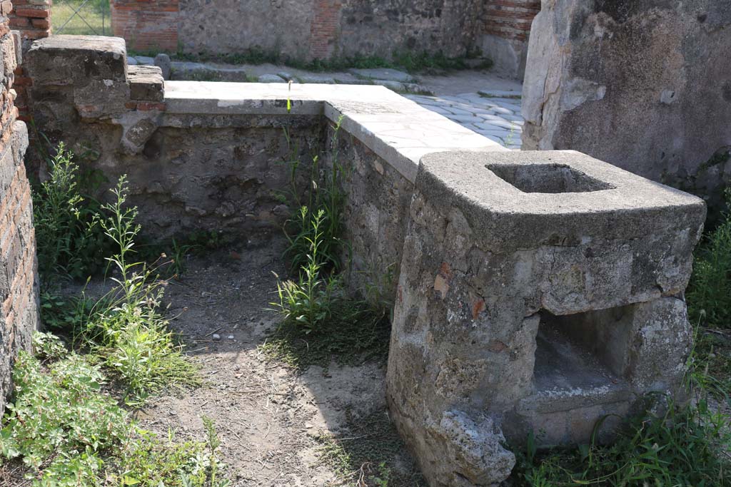 VI.1.2, Pompeii. December 2018. 
Looking west across hearth and counter from rear, towards Via Consolare. Photo courtesy of Aude Durand.
