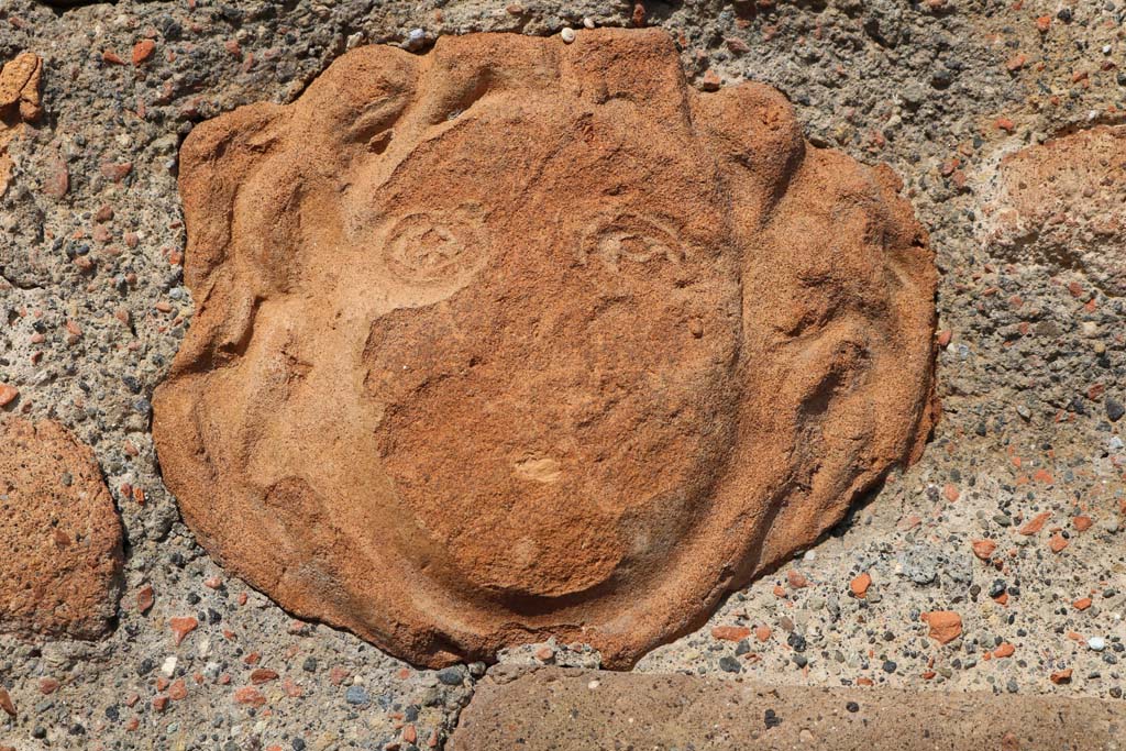 VI.1.4 Pompeii. December 2018. 
Terracotta mask of head embedded in masonry on south side of entrance doorway. Photo courtesy of Aude Durand.
