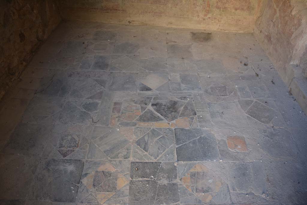 VI.2.4 Pompeii. December 2017. Looking south across flooring of opus sectile.
Foto Annette Haug, ERC Grant 681269 DÉCOR.
According to Laidlaw –
“This room (Diaeta 34) was badly damaged by the bomb; when the debris was cleared at the end of the war, the left (East) and entrance (North) walls were partly rebuilt, and the room reroofed. The pavement in opus sectile, which the blast had shattered, was restored approximately in the pattern of the original, with the missing parts filled in with cement or stray pieces found in the debris.”
See Laidlaw, A., and Stella M. S., 2014. The House of Sallust in Pompeii (VI.2.4): JRA 98. Portsmouth Rhode Island. (p.111). 
See Carratelli, G. P., 1990-2003. Pompei: Pitture e Mosaici. IV. Roma: Istituto della enciclopedia italiana, (p. 136-7, figs 84a, and 84b.)
