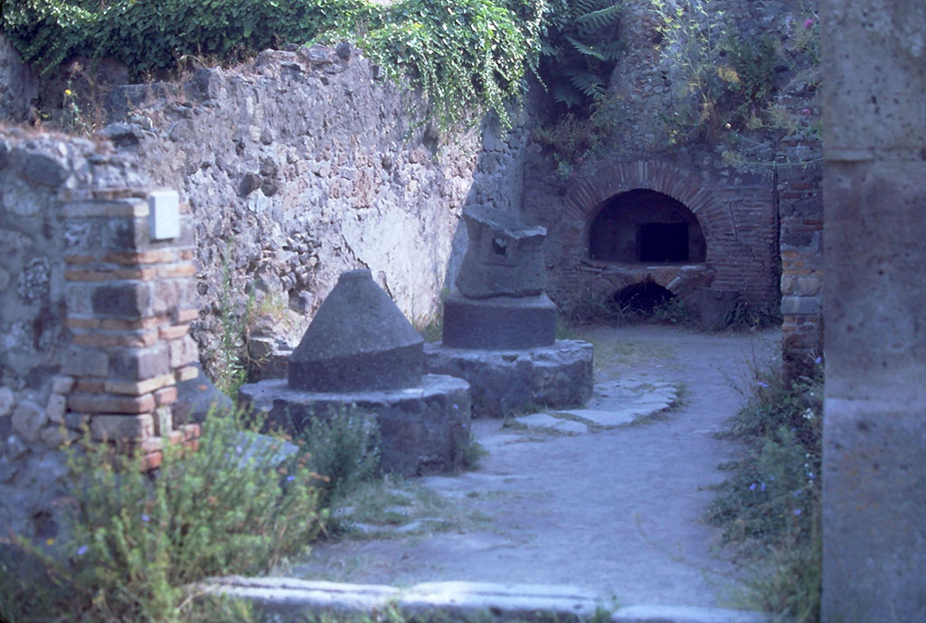 VI.2.6 Pompeii, Bakery, 18th August 1976. Looking east across bakery from entrance doorway.
Photo courtesy of Rick Bauer, from Dr George Fay’s slides collection.
