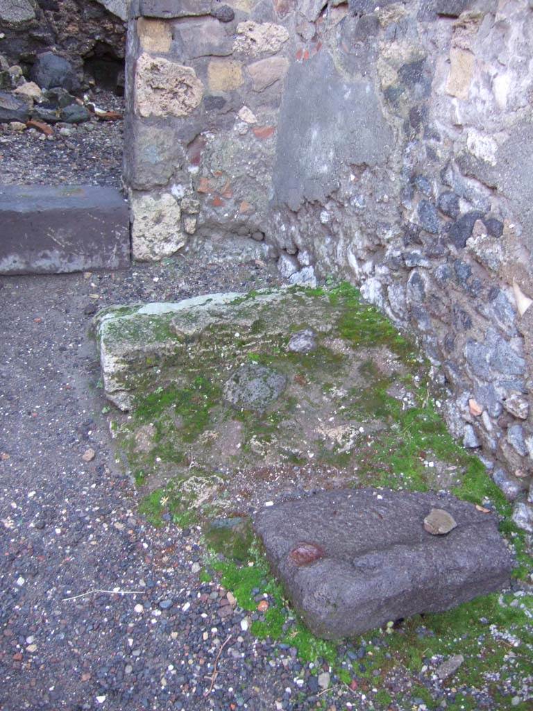 VI.2.6 Pompeii. December 2005. Stone base of stairs to upper floor near south wall, opposite the oven.
In the upper left of photo is the door to the rear room. 
According to Hobson in the corner under the site of the stairs, may have been the latrine.
See Hobson, B. 2009. Pompeii, Latrines and Down Pipes. Oxford, Hadrian Books, (p.185 & 188).
According to Fiorelli, at the side of the entrance doorway was the bread-shop, with hearth and the latrine.
See Pappalardo, U., 2001. La Descrizione di Pompei per Giuseppe Fiorelli (1875). Napoli: Massa Editore. (p.50)
 
