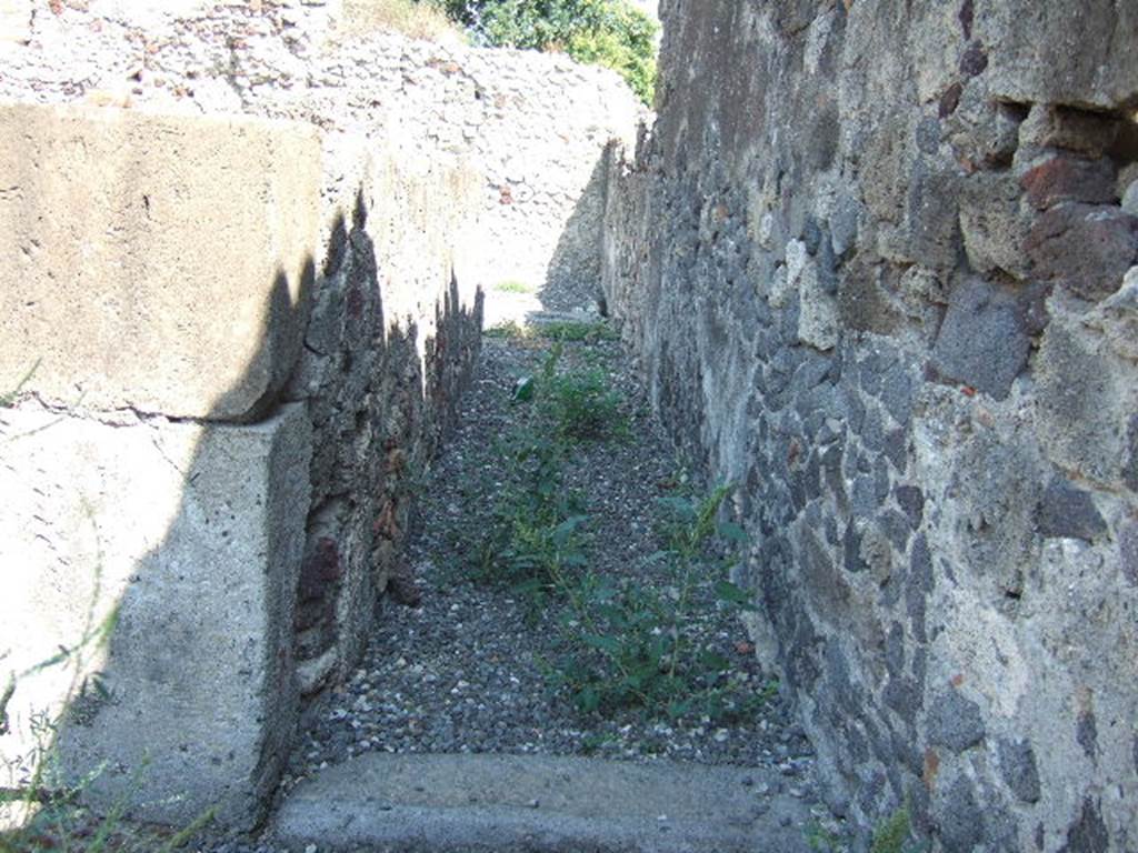 VI.2.12 Pompeii. September 2005. Corridor 4 on south side of tablinum, looking east to rear rooms.  