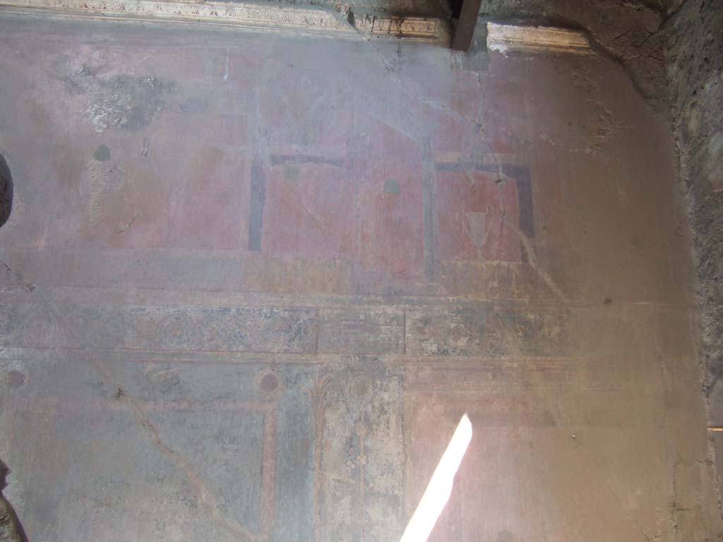 VVI.2.14 Pompeii. September 2005. East wall of triclinium, upper centre. 
According to Kuivalainen – 
on the upper left of this photo with the red background, but now destroyed, would have been “an almost naked young Bacchus with a thyrsus”.
See Kuivalainen, I., 2021. The Portrayal of Pompeian Bacchus. Commentationes Humanarum Litterarum 140. Helsinki: Finnish Society of Sciences and Letters, (p.99, B9).

