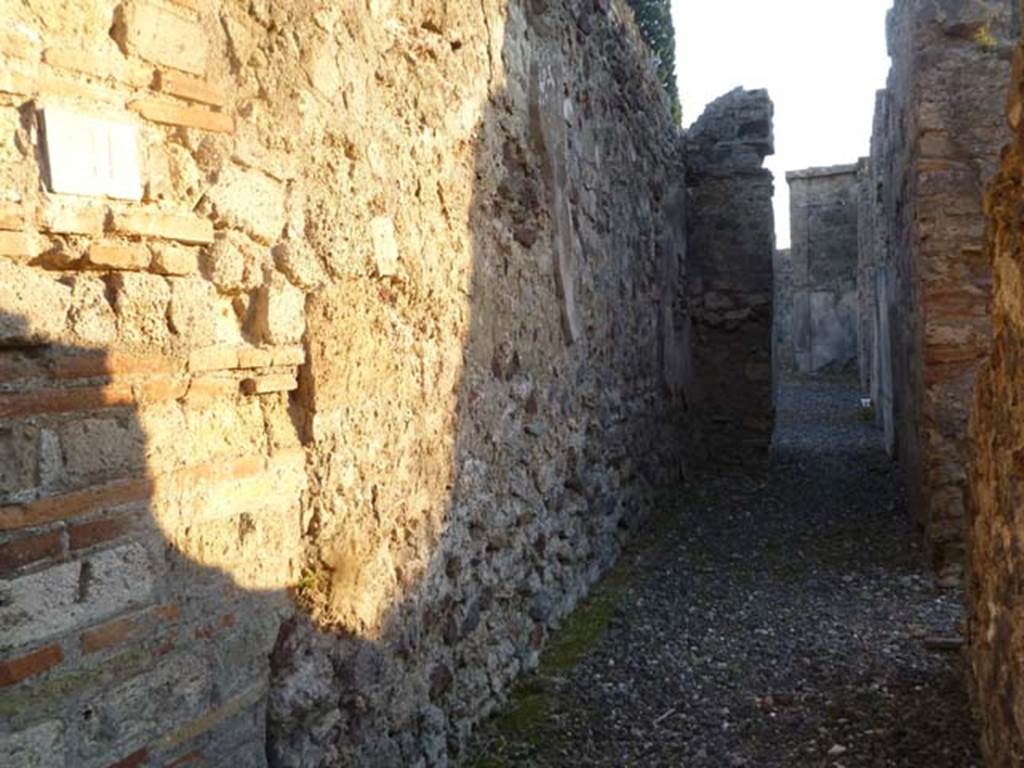 VI.2.16/21, Pompeii. May 2011. Looking west along corridor, leading from rear entrance (and kitchen area) at VI.2.21. The doorway to the kitchen area is on the right.
