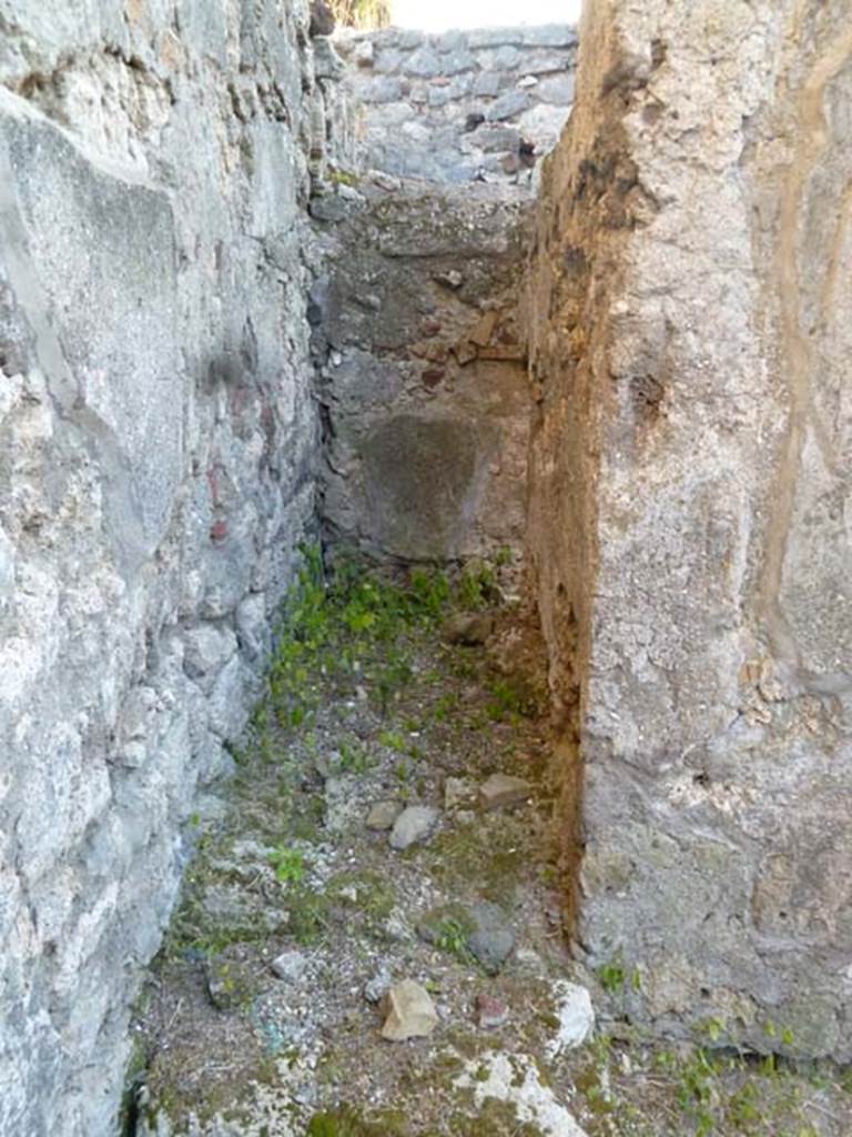 VI.2.16 Pompeii. May 2011. Looking west into room in south-west corner of atrium.
According to Fiorelli, this was the stairs to the upper floor.  According to Hobson, the narrow room with a step up over a threshold stone and a window at the far end was possibly a latrine. However, an area in the kitchen with a low wall, on which a screen might have been stood and again with a window, suggests the position of a latrine.  Either or both could be a latrine.
See Hobson, B., 2009. Latrinae et foricae: Toilets in the Roman World. London; Duckworth. (p.68)

