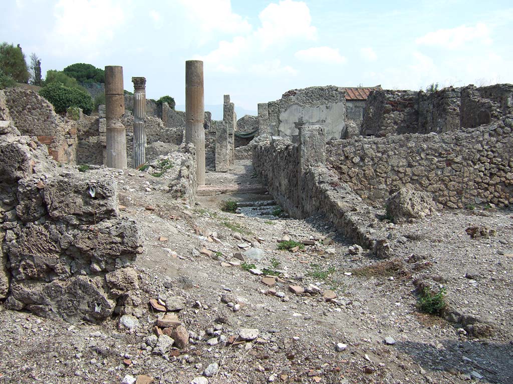 VI.2.18 Pompeii. September 2005. Looking east from area of rear entrance.
According to Garcia y Garcia, two bombs fell here that caused the grave ruin and abandonment of the area.
The prothyron was destroyed, two rooms to the south of it, and a part of the atrium.
The north perimeter wall was also destroyed for a large area of 4 x 4m.
See Garcia y Garcia, L., 2006. Danni di guerra a Pompei. Rome: L’Erma di Bretschneider. (p.74)
