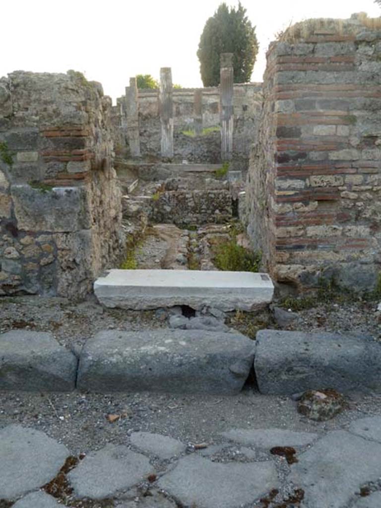 VI.2.19 Pompeii. May 2011.  Entrance doorway, looking west.
According to Fiorelli, next to the city wall was the last house in Vicolo di Modesto. In the Samnite era it would have had noble decoration on its walls, but then it was transformed into an inn (stabulum), with large stables (scuderia), with many rustic rooms, dormitories or hay-lofts above them. There was an uncovered area, in the back of which was a passageway that would have been the fauces/corridor from which one would have reached the garden area; which seems to have been used in the last times, together with the rustic rooms built around its interior, as an inn or a hostel. VI.2.18 was described as the rear exit of the building with the main entrance on the eastern vicolo (that is VI.2.19 on Vicolo di Modesto)
See Pappalardo, U., 2001. La Descrizione di Pompei per Giuseppe Fiorelli (1875). Napoli: Massa Editore. (p.51)

