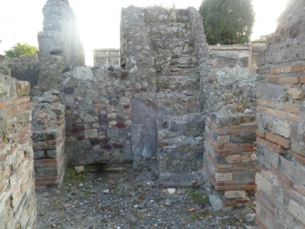 VI.2.20 Pompeii. May 2011. Looking west towards stone staircase.
On the left and the right would be the doorways into the two rooms described by Fiorelli as being used for either dormitories or dining areas.
Ahead is the bricked-up wall at the end of the fauces which would have led towards the atrium of VI.2.17, and the stone steps to the upper floor.

