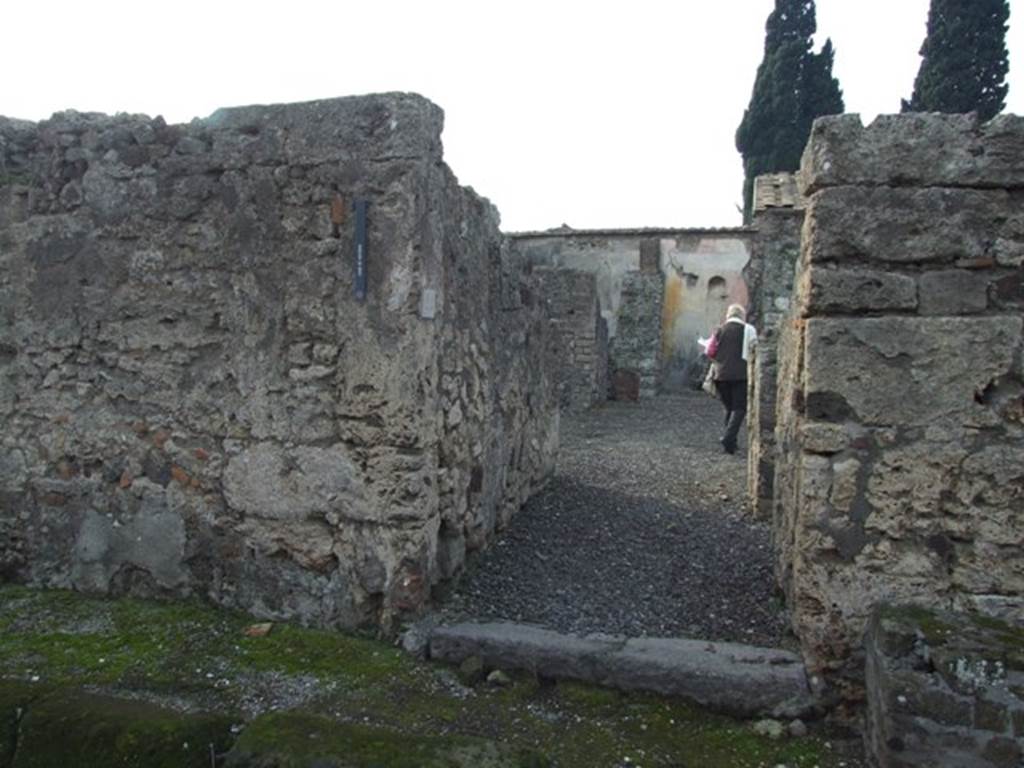 VI.2.24 Pompeii. December 2007. Entrance doorway, with the remains of one of the benches outside on the right.