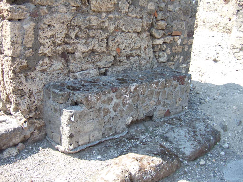 VI.2.24 Pompeii. May 2011. Entrance doorway, with the remains of one of the benches outside on the right.
