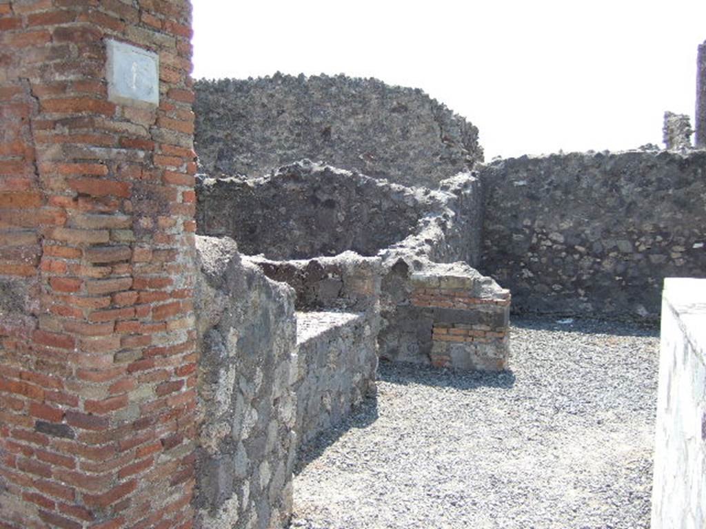 VI.4.1 Pompeii. May 2006. Looking south-east from entrance, towards podium, linked to VI.4.2, and doorway to room in south-east corner, possibly a cubiculum.



