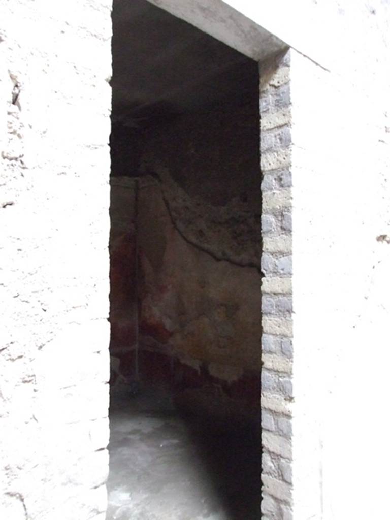 VI.8.5 Pompeii. March 2009. Doorway to room 9, cubiculum. 
According to Bianco in Rivista di Studi Pompeiani, when found this cubiculum was beautifully decorated.
Today the decoration has been totally lost.
The lower walls would have had a dark red dado (zoccolo).
The walls were divided into red and yellow panels, the middle panel on each wall was yellow.
In the central yellow panel were mythological paintings.
Apollo and Daphne on the north wall.
Europa on the Bull on the south wall.
Phryxus and Helle on the west wall.
On the east wall was the doorway to the atrium.
On high was a frieze showing Amazons, this was interrupted in the centre of the west wall with a painting of Venus Pompeiana.
See Bianco, A. Il fregio delle Amazzoni nella Casa del Poeta Tragico a Pompei: Rivista di Studi, XVIII, 2007, Roma: Lerma di Bretschneider, p.54-66 with photos.
See Bragantini, de Vos, Badoni, 1983. Pitture e Pavimenti di Pompei, Parte 2. Rome: ICCD. (p.173, room numbered as cubiculum 6a).
