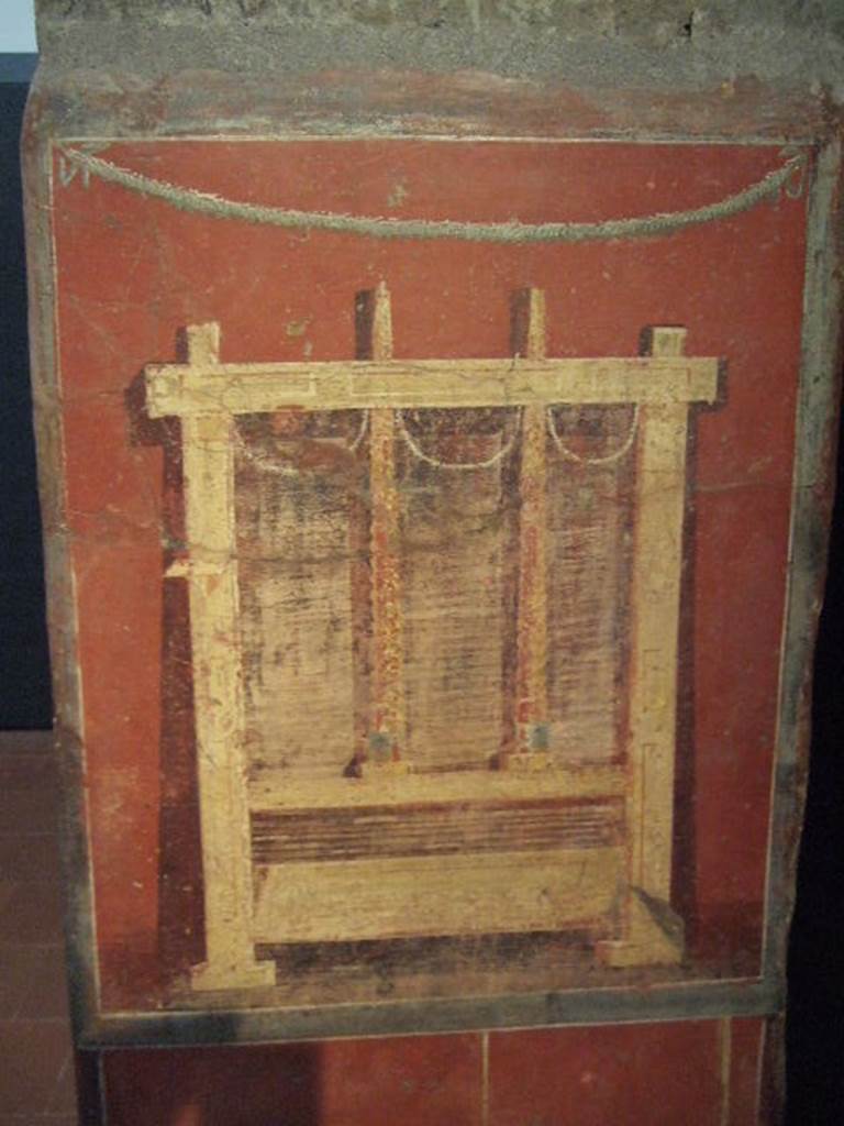 Pillar found in the Fullonica at VI.8.20.   Painting of fullers press for drying the wet cloths.  Now in Naples Archaeological Museum.  Inventory number 9974.