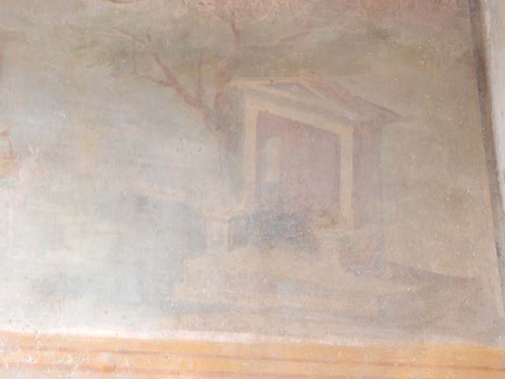 VI.8.23 Pompeii. May 2017. Detail of north end of sacred landscape showing a small temple next to a tree with a seated divinity.  Photo courtesy of Buzz Ferebee.
