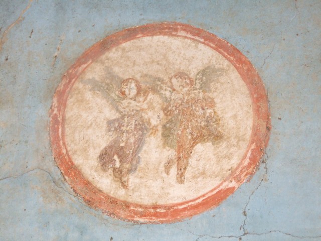 VI.9.6 Pompeii. March 2009. Room 8, painted medallion with two winged figures, from east wall.