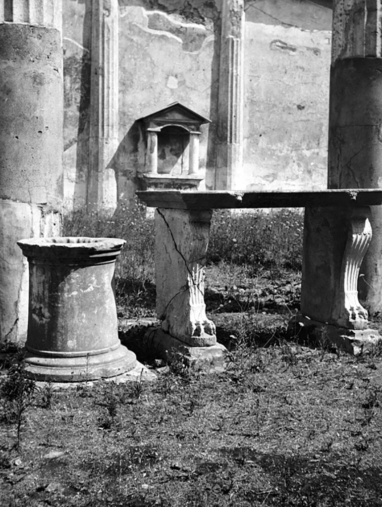 VI.9.6 Pompeii. March 2009. Room 17, rear of marble table in garden area. Looking west across portico and tablinum to front of house.
