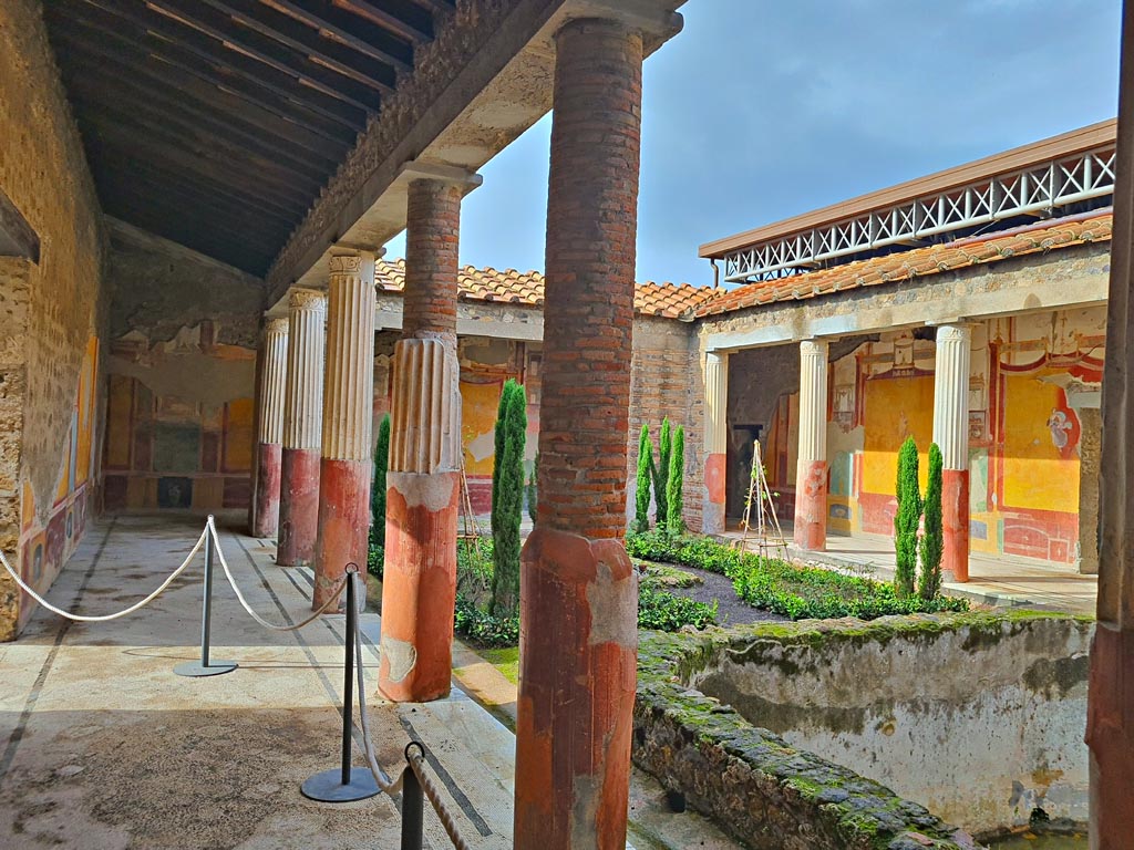 VI.9.6 Pompeii. November 2023.
Room 6, looking west along south portico of peristyle towards west wall in south-west corner.Photo courtesy of Giuseppe Ciaramella.

