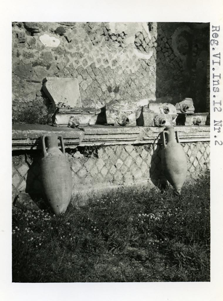 VI.12.2 Pompeii. Pre-1937-39. Amphorae and water-spouts on display, on north side of rear peristyle. 
Photo courtesy of American Academy in Rome, Photographic Archive. Warsher collection no. 36.
