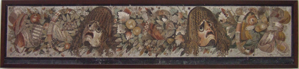 VI.12.2 Pompeii. Mosaic of two tragic masks between a group of flowers, fruits and garlands. 
Found in VI.12.2 as a threshold dividing the fauces (room 53) from the atrium, on 28th October 1830. 
See Mau, A., 1907, translated by Kelsey F. W. Pompeii: Its Life and Art. New York: Macmillan. (p. 290).
Now in Naples Archaeological Museum. Inventory number 9994.
According to Fiorelli, the tablinum 33 was also separated from the atrium, by a mosaic threshold of masks and garlands.
He described this as reputed to be one of the most stupendous works of art, due to the excellence of the design, colours and workmanship.
See Pappalardo, U., 2001. La Descrizione di Pompei per Giuseppe Fiorelli (1875). Napoli: Massa Editore, (p.71)
See PAH II, 240.
