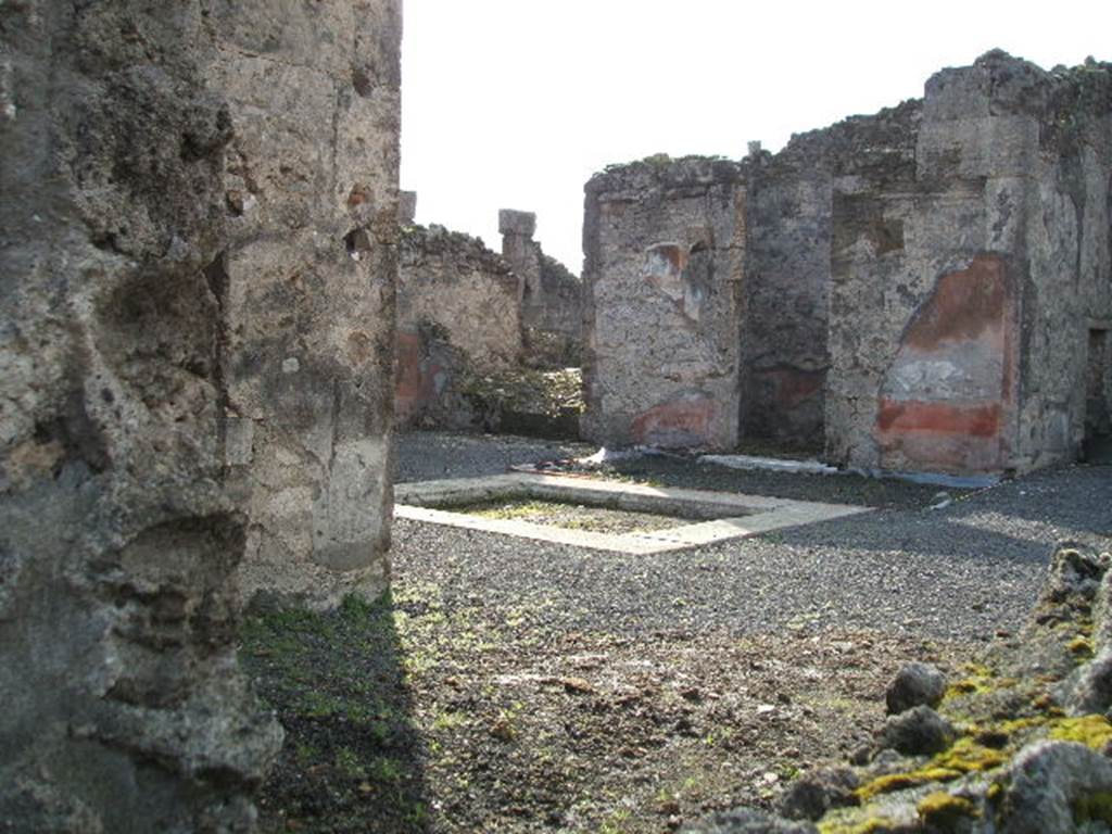 VI.13.8 Pompeii. December 2004. Looking south-west from rear entrance, towards atrium. According to Garcia y Garcia, in 1943 a bomb destroyed the rear entrance. The three nearby rooms on the south-east side of the peristyle were destroyed as well as a good part of the east wall. See Garcia y Garcia, L., 2006. Danni di guerra a Pompei. Rome: LErma di Bretschneider. (p.86-87)
According to Della Corte, the peristyle was transformed into a weaving workshop, probably after the earthquake of 62AD. The workers took time to scratch their names in the portico.  The names of seven men were found - Vesbius or Vesbius Tamudianus, Felix, Ephesus, Xanthus, Successus, Faustus, and Florus: The  names of eleven women were found - Vitalis, Florentina, Amaryllis, Ianuaria, Heracla, Maria, Lalage, Damalis,  .rusa,  .a., Baptis, and Doris.  Della Corte noted that two of the names were Jewish  that of Maria, and Vesbius Tamudianus.    
See Della Corte, M., 1965.  Case ed Abitanti di Pompei. Napoli: Fausto Fiorentino. (p.121) [CIL IV (1493-1509]  
According to Epigraphik-Datenbank Clauss/Slaby (See www.manfredclauss.de), these read as 
Vesbius Tamudianus     [CIL IV 1493]
Pottttas 
X                  [CIL IV 1494]
Vesbius     [CIL IV 1495]
Quibusos  [CIL IV 1496] 
Felix           [CIL IV 1497]
Felix           [CIL IV 1498]
Nero Poppaeeses istis   [CIL IV 1499] 
Cum           [CIL IV 1500]
Vibius        [CIL IV 1501]
Mamoe      [CIL IV 1502] 
Ephesus 
Fututor      [CIL IV 1503] 
Felix           [CIL IV 1504] 
Xanthus    [CIL IV 1505]
Successus     [CIL IV 1506]
Maria pe(nsi) stamen       [CIL IV 1507] 
Nua[3] 
Procu/lus hoc                    [CIL IV 1508]
Faustus Felix F[l]oru(s)   [CIL IV 1509]


