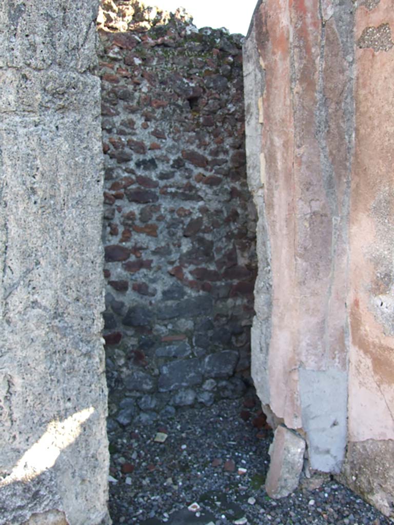 VI.14.43 Pompeii. December 2006. Looking east across atrium towards doorway to room 8, on right of centre.  Room 7, (on left) looking through tablinum to west portico, and north side of rear of house. According to Jashemski, the peristyle garden, excavated in 1839, entered by a corridor from the atrium, had walls decorated in the first style. The portico which enclosed the garden on the north and part of the west sides was supported by four fluted columns joined by a low wall.
See Jashemski, W. F., 1993. The Gardens of Pompeii, Volume II: Appendices. New York: Caratzas. (p.151)

