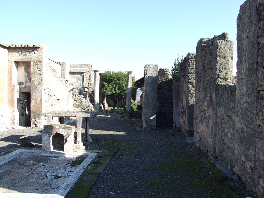 VI.14.43 Pompeii. December 2007. Looking east across south side of atrium to tablinum, from doorway of room 11.