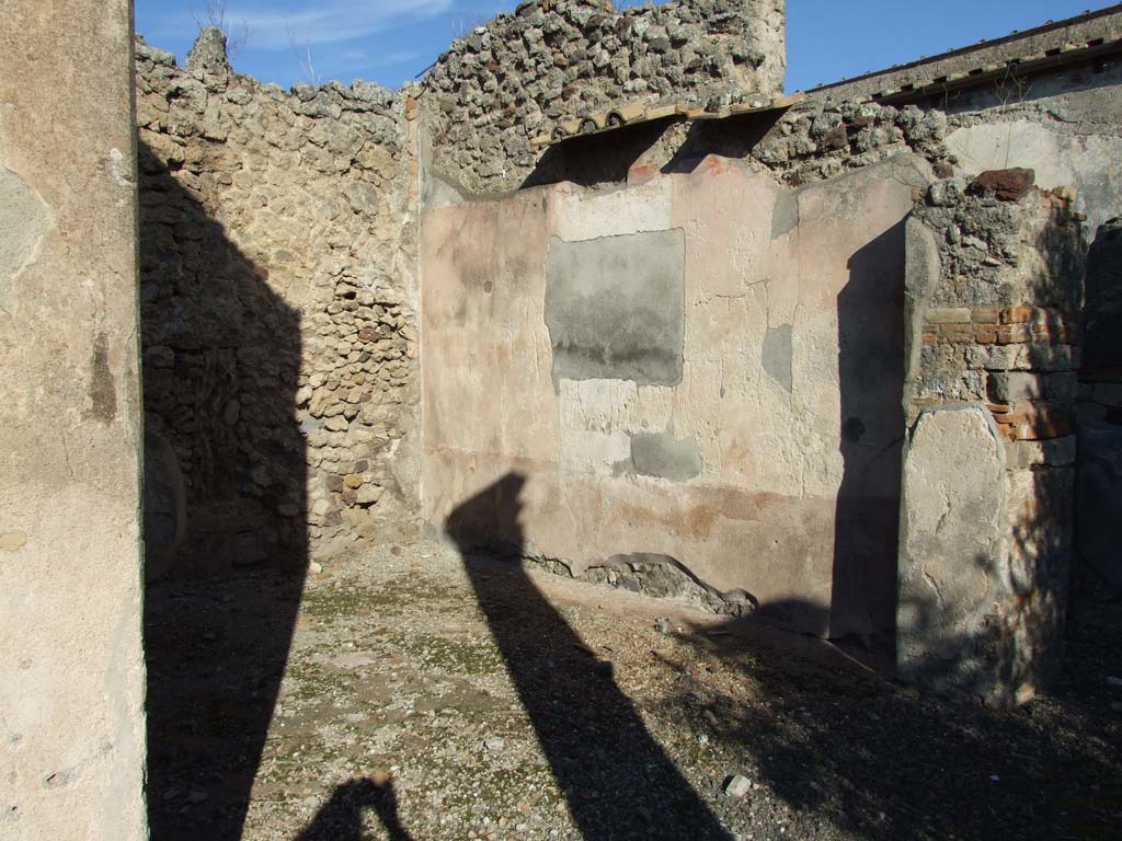 VI.14.43 Pompeii. December 2007. Doorway to room 16, exedra on north side of peristyle. Looking towards east wall.
According to PPM, the painting of Pindar and Corinna was found on the east wall.
Above a black zoccolo, the middle zone of the wall had a central aedicula with a red panel on either side. 
At the centre was the wide gap left by the detachment of the central part of the painting, showing Pindar and Corinna (Helbig 1379, NAP inv. 9269).
See Carratelli, G. P., 1990-2003. Pompei: Pitture e Mosaici. Vol.5. Roma: Istituto della enciclopedia italiana, (p.463). 
According to Schefold (1957) the painting was found on the north wall. 
Schefold said in 1962, that the painting had been transferred to Naples Archaeological Museum, Pindar, Myrtis and Corinna.
See Schefold, K., 1962. Vergessenes Pompeji. Bern: Francke. (Pl. 57, 2) 
According to Richardson, the wall painting of Pindar and Corinna, found on the north wall, had the inventory number NAP 9269.
He also gave the Helbig reference as Helbig 1379.
See Richardson, L., 2000. A Catalog of Identifiable Figure Painters of Ancient Pompeii, Herculaneum. Baltimore: John Hopkins. (p.67). 
However, NAP 9269 is a painting of Bacchus and Silenus, from VII.7.32, and according to Elia the painting of Pindar, Myrtis and Corinna was inventory number: s.n (senza numero).
See Elia, O. (1932): Pitture murali e mosaici nel Museo Nazionale di Napoli. Rome: La Libreria dello Stato. (p.14, no.5: Gara di citaredo).
According to Helbig the exedra, left from peristyle, contained a painting of: Gods (deification of) of Homer. This had the same number as the above.
See Helbig, W., 1868, Wandgemälde der vom Vesuv verschütteten Städte Campaniens. Leipzig: Breitkopf und Härtel.  (1379).
