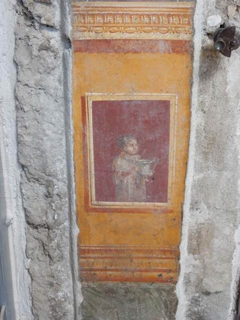 VI.15.1 Pompeii. May 2017. 
Detail of painted panel on south end of lower west wall of atrium, leading onto peristyle. Photo courtesy of Buzz Ferebee.

