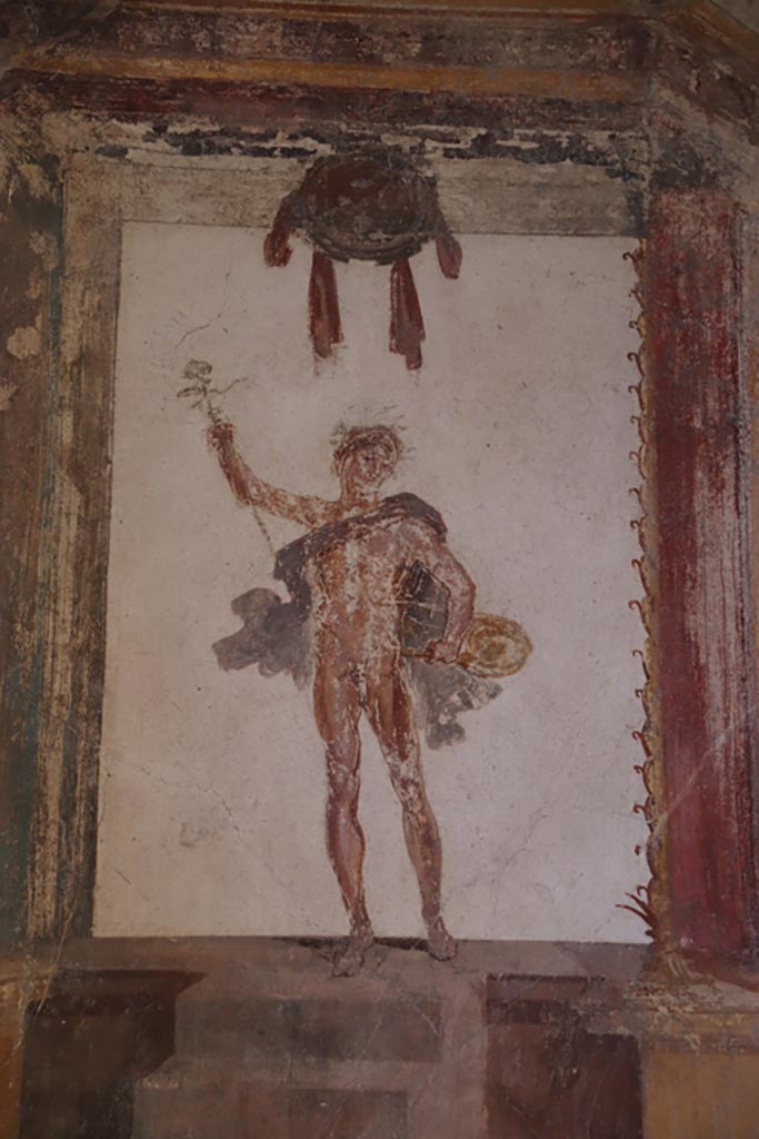 VI.15.1 Pompeii. October 2023. 
Upper south wall of oecus at east end, painted figure of Mercury. Photo courtesy of Klaus Heese.
