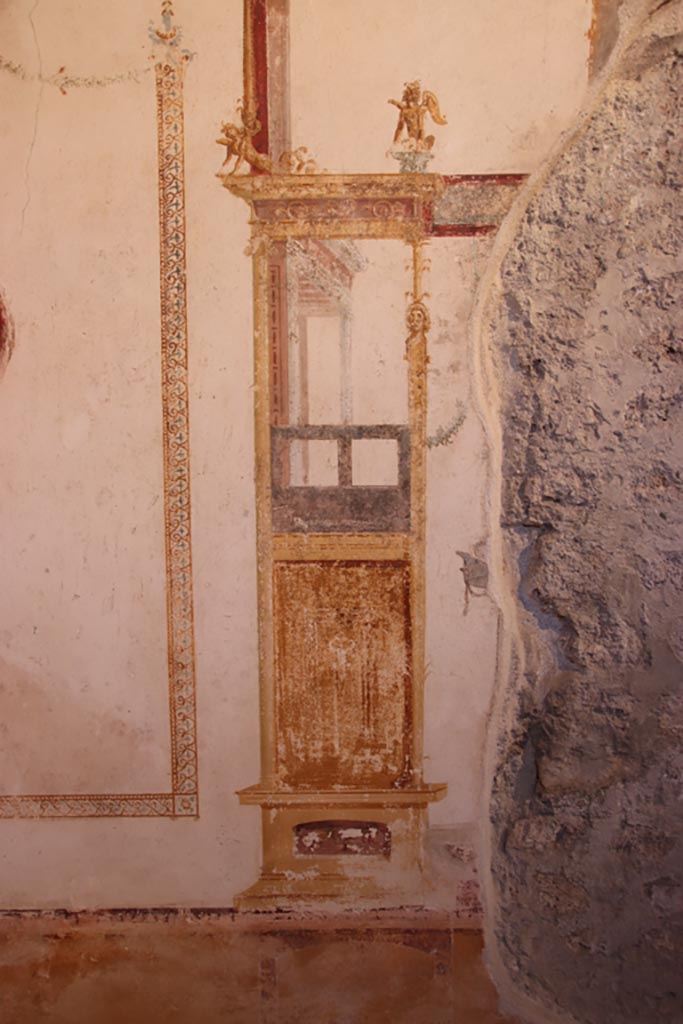 VI.15.1 Pompeii. October 2023. 
Detail of painted decoration from panel on west wall of oecus, on south end of central panel. 
Photo courtesy of Klaus Heese.

