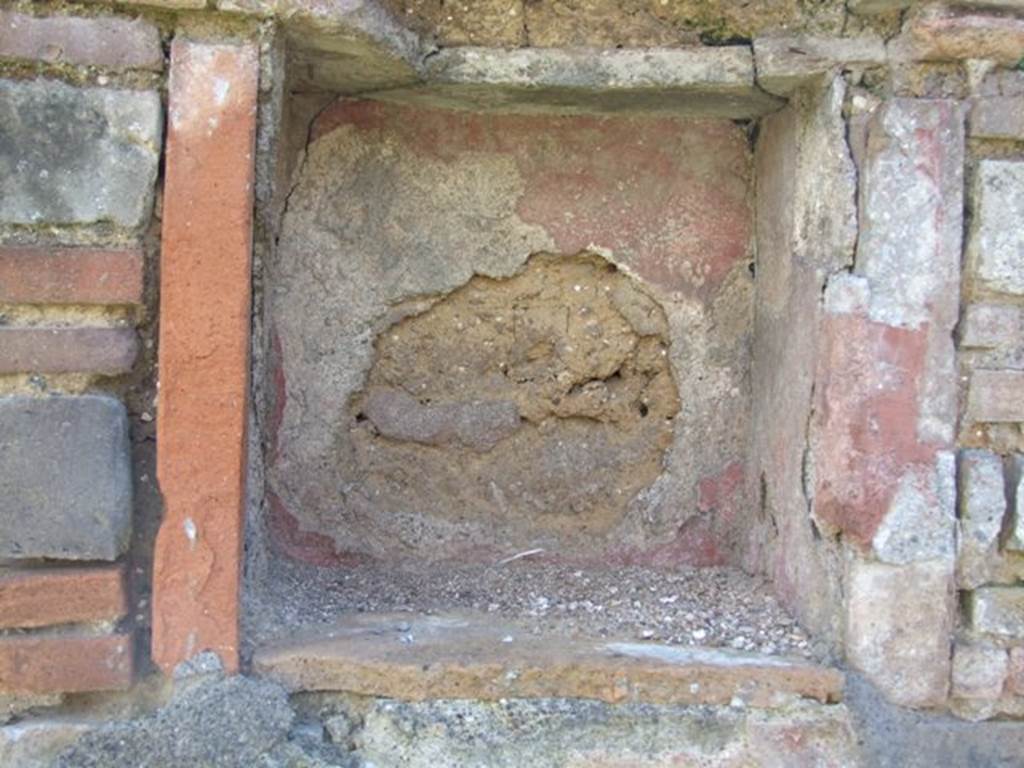 VI.16.20 Pompeii. March 2009. Niche in south wall, originally this may have been in a rear room of VI.16.21/22. According to Boyce, numbered VI.16.20-24.  In the central room on the south side of the house is a rectangular niche. It is in the north side of a pilaster which projects from the east wall (now collapsed). On the wall below the niche, were painted two large yellow serpents on a red background. Not. Scavi, 1908, 182.
See Boyce G. K., 1937. Corpus of the Lararia of Pompeii. Rome: MAAR 14. (p.59, no.225)  
