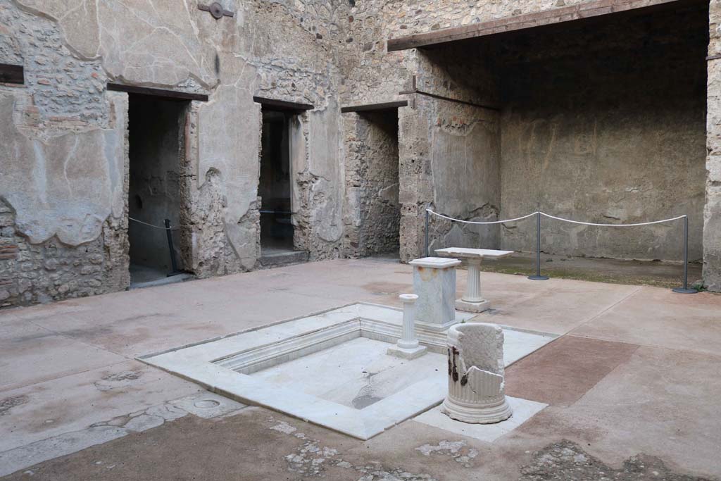 VII.1.47 Pompeii. April 2019. Looking north-west across atrium 3.
On the left is the east end of the entrance corridor, then the two doorways belong to the room on west side of atrium.
The doorway to Exedra 10 can be seen in the centre.
The doorway on the right leads into the corridor 9, to the kitchen area in VII.1.46.
Photo courtesy of Rick Bauer.


