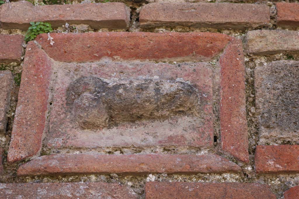 VII.3.23, Pompeii. December 2018. 
Plaque of terracotta and tufa showing phallus, from north side of doorway. Photo courtesy of Aude Durand.
