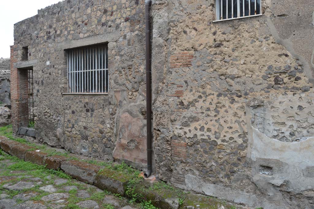 VII.3.26 Pompeii. October 2017. 
Blocked entrance, now with a barred window, looking north-west on Vicolo del Panettiere towards VII.3.27/26, on right.
Foto Taylor Lauritsen, ERC Grant 681269 DCOR.
