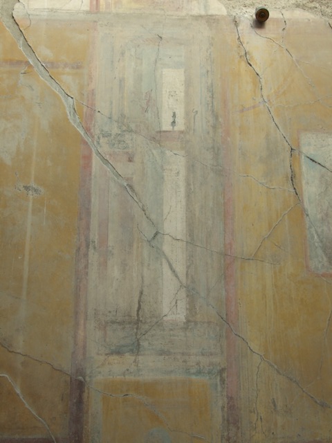 VII.4.31 Pompeii.  March 2009.  Room 12. Oecus. South wall. Remains of a Wall painting of Venus on a sea creature, with two Cupids unfolding her mantle as a sail. Venus is leaning on the shoulder of another figure, followed  by another Cupid playing the pipes.