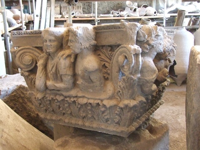 VII.4.57 House of the Figured Capitals. Drunken satyr and a maenad on a capital. This faced the street on the top of right hand side of entrance.