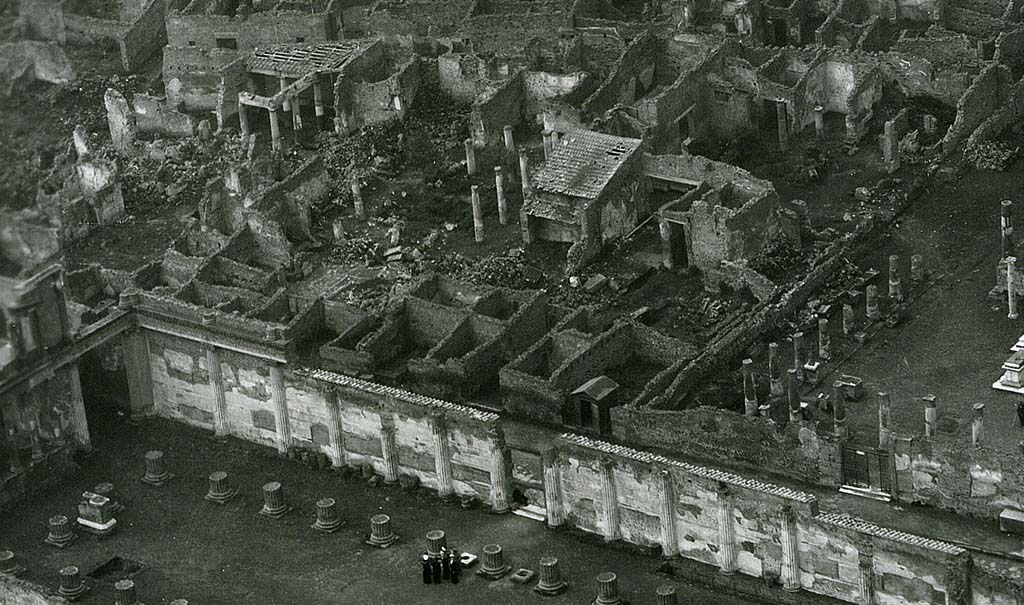 VII.7.2 Pompeii. 1944, detail taken from USAAF aerial photo.
Looking north-west across the Basilica and Via Marina, lower left in photo.
On the north side of the Via Marina, in the upper part of the photo, the house of House of Romulus and Remus (VII.7.10), and House of Tryptolemus (VII.7.5 and VII.7.2) can be seen on the west side of the Temple of Apollo, which is on the right. 
Photo courtesy of Rick Bauer. 

