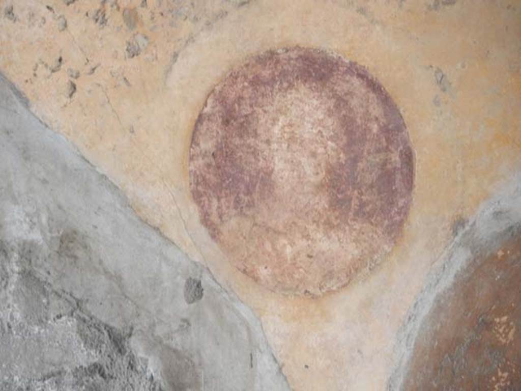 VII.7.5 Pompeii, May 2018. 
Room n, detail from south wall with yellow painted panel in middle area of wall, with painted medallion of female figure with feather fan.
Photo courtesy of Buzz Ferebee.
