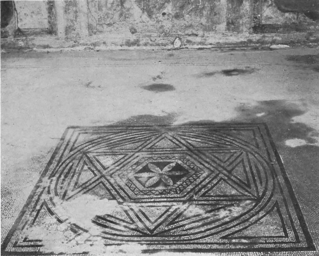 VII.7.5 Pompeii. c.1930. Flooring from the triclinium (n) on the right of the peristyle
This triclinium was constructed in the period when the symmetry of the house number 2 was destroyed by its annexation to house number 5. 
On the other hand, this pavement does not belong to the last modification of the house, since it was patched at the insertion of the limestone sill upon which rests piers of the block and brick construction which was characteristic of the building activities following the earthquake of 63AD. 
This centre probably belongs to the first half of the first century AD. 
The tesserae of the central square are small (0.06cm) and the black ones are badly worn; the workmanship is poor.
The design of this centre is merely an adaptation of the familiar pattern showing a hexagon surrounded by triangles to make a star, which in its turn is enclosed in a larger hexagon. When the hexagon has been included in a circle and the circle in a square, the general outline of the centre is complete.
A six-petalled flower on a black background framed in an ornamental border forms the centre of the composition.
See Blake, M., (1930). The pavements of the Roman Buildings of the Republic and Early Empire. Rome, MAAR, 8, (p.114, pl.39, tav.3)
