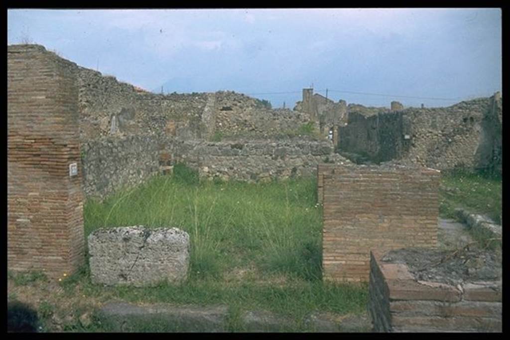VI.9.37 Pompeii.  Entrance with podium, on Vico del Balcone Pensile. 
Looking north into VII.9.36.  Photographed 1970-79 by Gnther Einhorn, picture courtesy of his son Ralf Einhorn.
