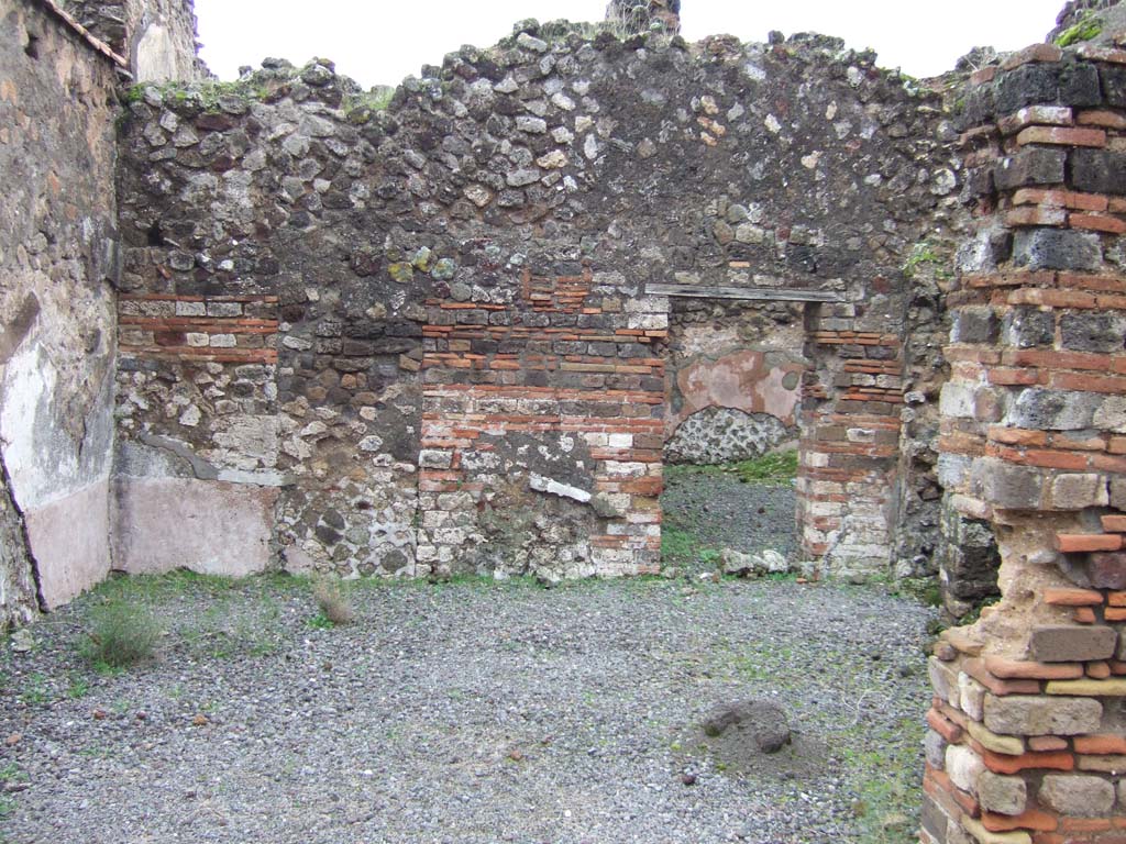 VII.10.2 Pompeii. December 2005. Looking east across shop towards doorway to rear room.