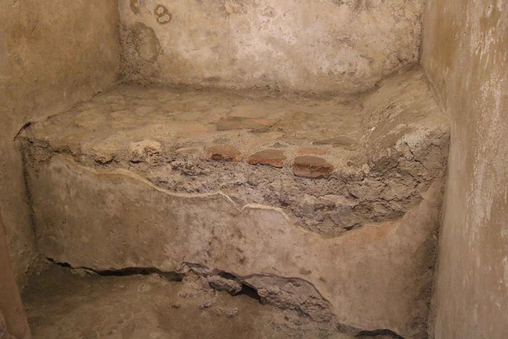 VII.12.18, Pompeii. December 2018. Prostitute’s room, with stone bed and pillow. Photo courtesy of Aude Durand.