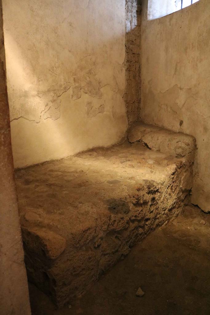 VII.12.18, Pompeii. December 2018. 
Stone bed and pillow in room for prostitute. Photo courtesy of Aude Durand.

