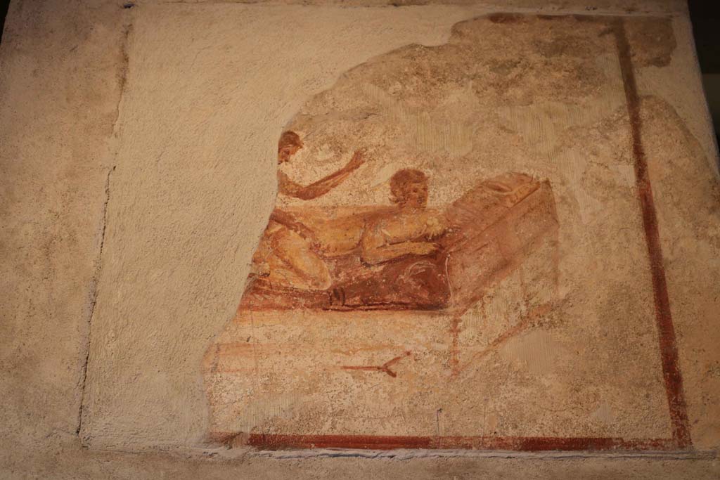 VII.12.18 Pompeii. April 2022. Part of remains of painted erotic wall fresco on frieze. Photo courtesy of Giuseppe Ciaramella.

