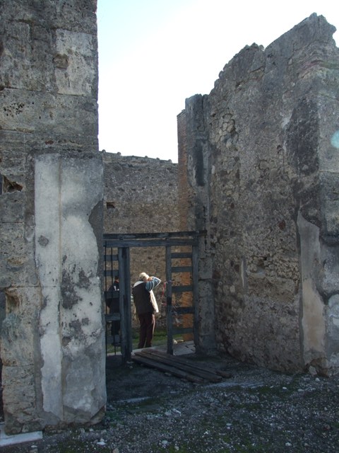 VII.15.2 Pompeii. December 2007. Fauces, or entrance corridor, looking south from atrium.  This entrance corridor had a mosaic depicting a colonnaded sea front revealing the prows of ships through the six arches.  
A dolphin and an anchor were also in the surround.  This is how the house got its name.
