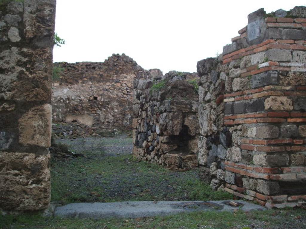 VII.16.3 Pompeii. December 2004. Looking north through entrance doorway towards atrium.
The doorway on the right, in the east wall of the entrance corridor, leads into VII.16.4.
According to Garcia y Garcia, the atrium and four rooms surrounding it were completely destroyed.
This meant the loss of all the plaster decoration from the walls. It was partially restored in 1950.
See Garcia y Garcia, L., 2006. Danni di guerra a Pompei. Rome: L’Erma di Bretschneider. (p.131, and figs.308-9)

