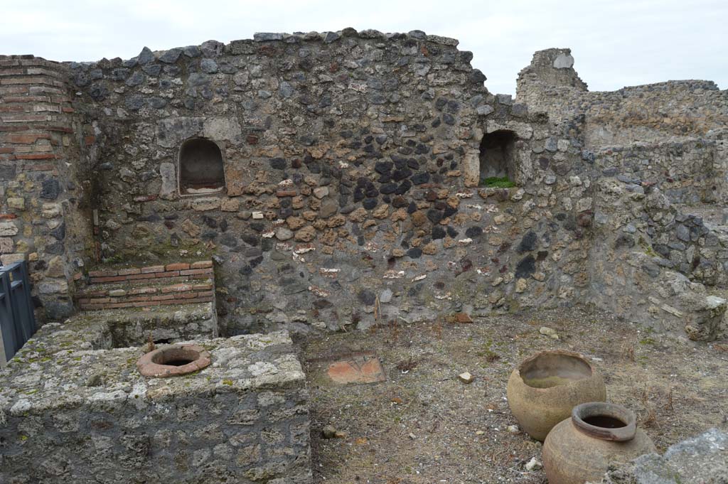 VII.16.7 Pompeii. March 2018.
Looking west towards entrance doorway, on left, counter with display shelves and inset urn/s, and west wall with two niches.
Foto Taylor Lauritsen, ERC Grant 681269 DÉCOR.
